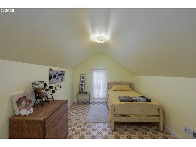 a bedroom with a bed and window