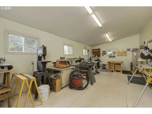 a gym room with furniture and a fan