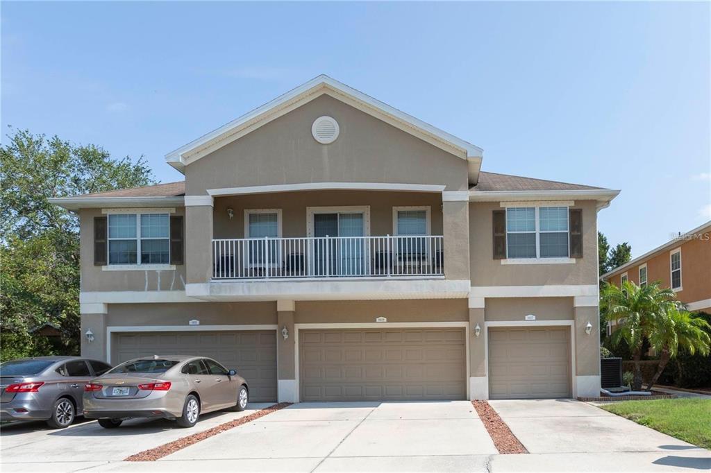 8409 Blue Rock Drive New Port Richey, FL 34653 - Photo 1 of 36 a front view of a house with a parking space