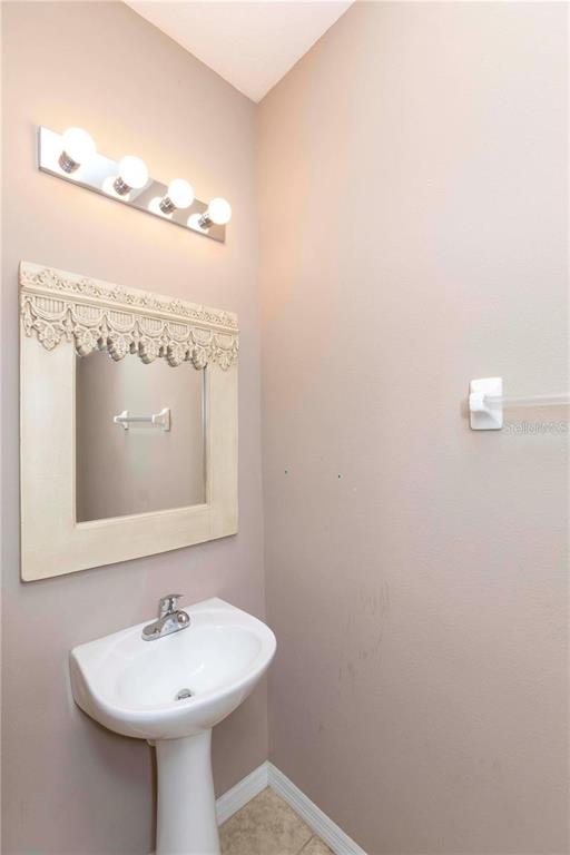 8409 Blue Rock Drive New Port Richey, FL 34653 - Photo 17 of 36 a bathroom with a sink a mirror and vanity