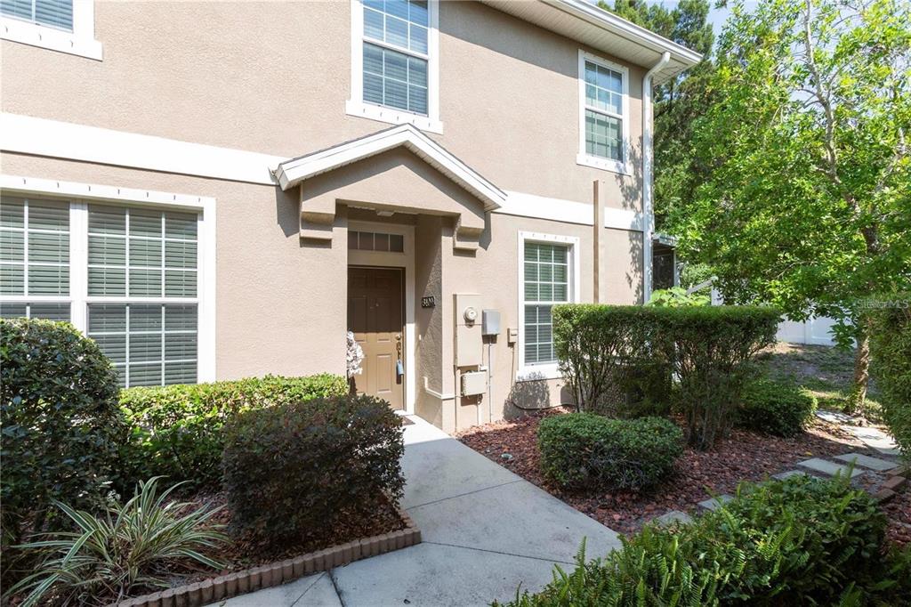 8409 Blue Rock Drive New Port Richey, FL 34653 - Photo 2 of 36 a front view of a house with garden