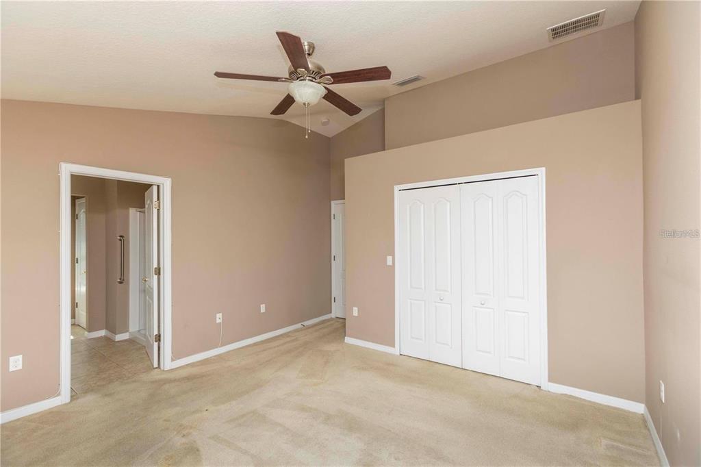 8409 Blue Rock Drive New Port Richey, FL 34653 - Photo 21 of 36 an empty room with a ceiling fan and a window