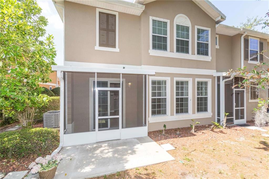 8409 Blue Rock Drive New Port Richey, FL 34653 - Photo 28 of 36 front view of a brick house with a yard