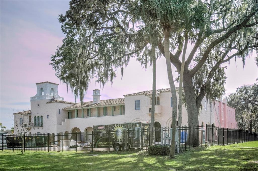 8409 Blue Rock Drive New Port Richey, FL 34653 - Photo 34 of 36 a front view of a building with a garden and trees