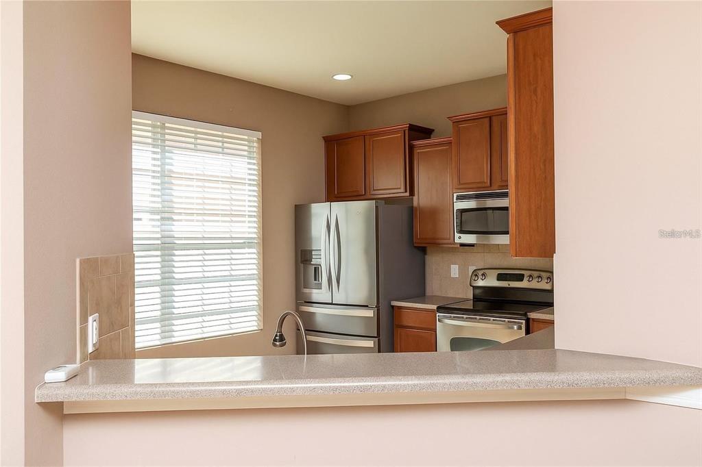 8409 Blue Rock Drive New Port Richey, FL 34653 - Photo 7 of 36 a kitchen with stainless steel appliances a refrigerator and a sink