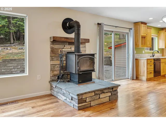 a view of a room with wooden floor and windows