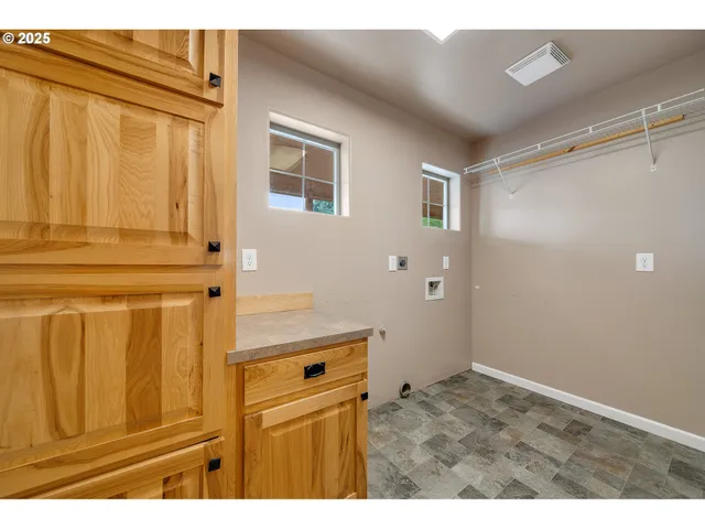 a view of empty room with wooden floor and fireplace
