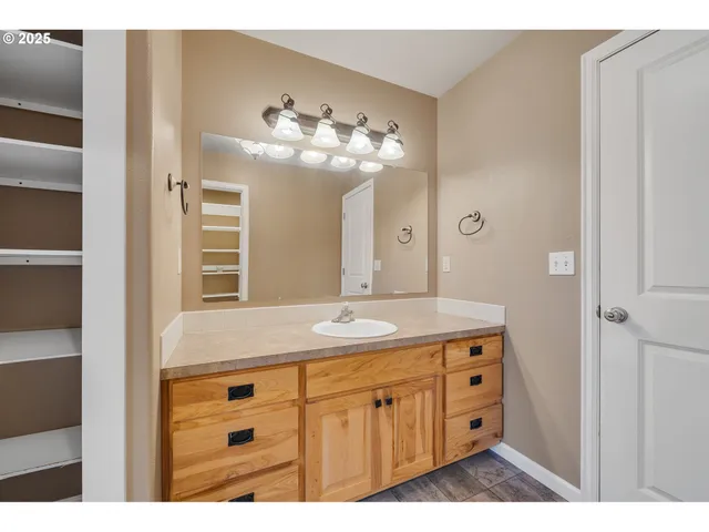 a bathroom with a tub a window and a shower
