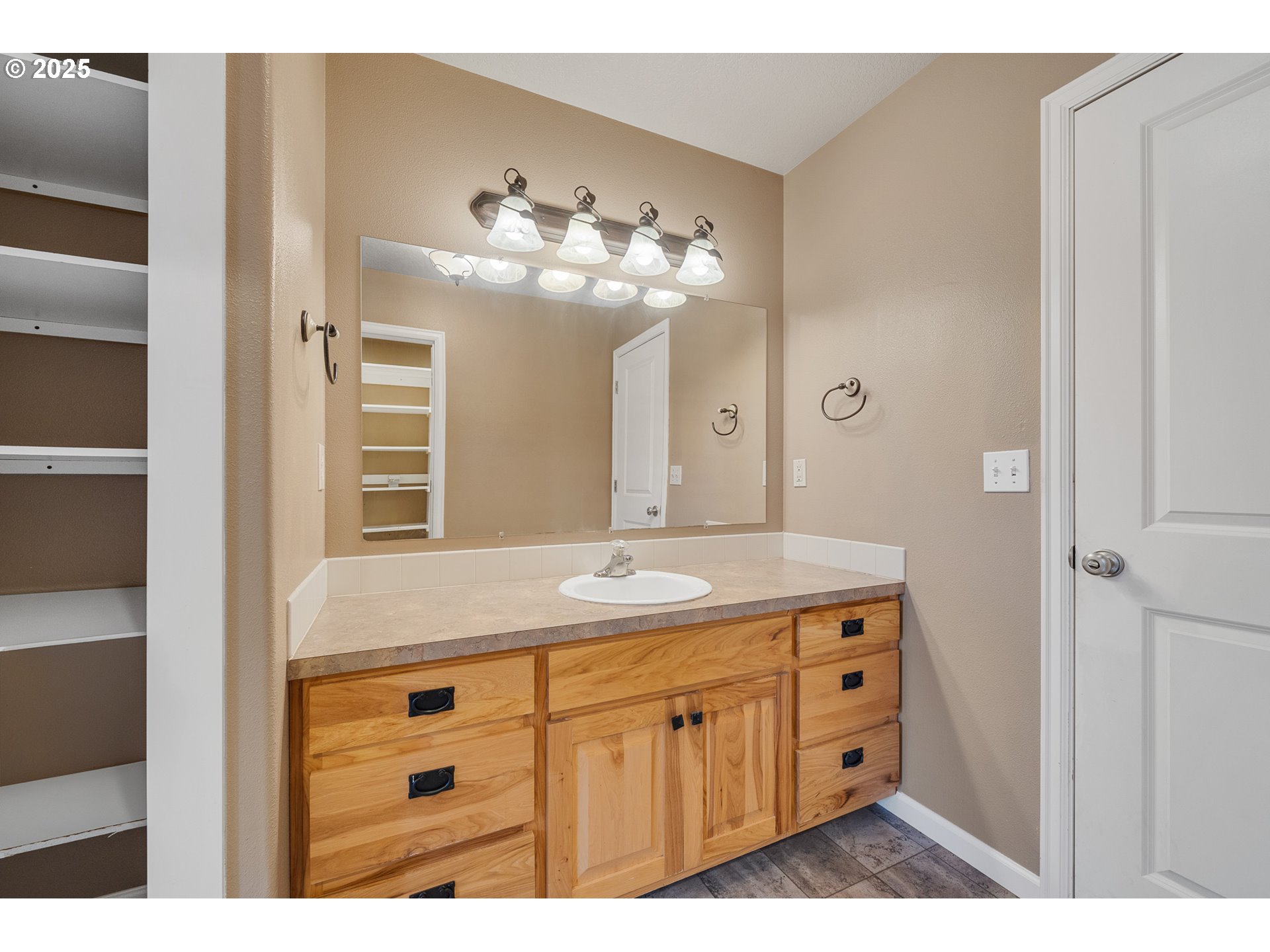 3355 Hubert Road Tillamook, OR 97141 - Photo 23 of 35 a bathroom with a granite countertop sink a light fixture and a mirror