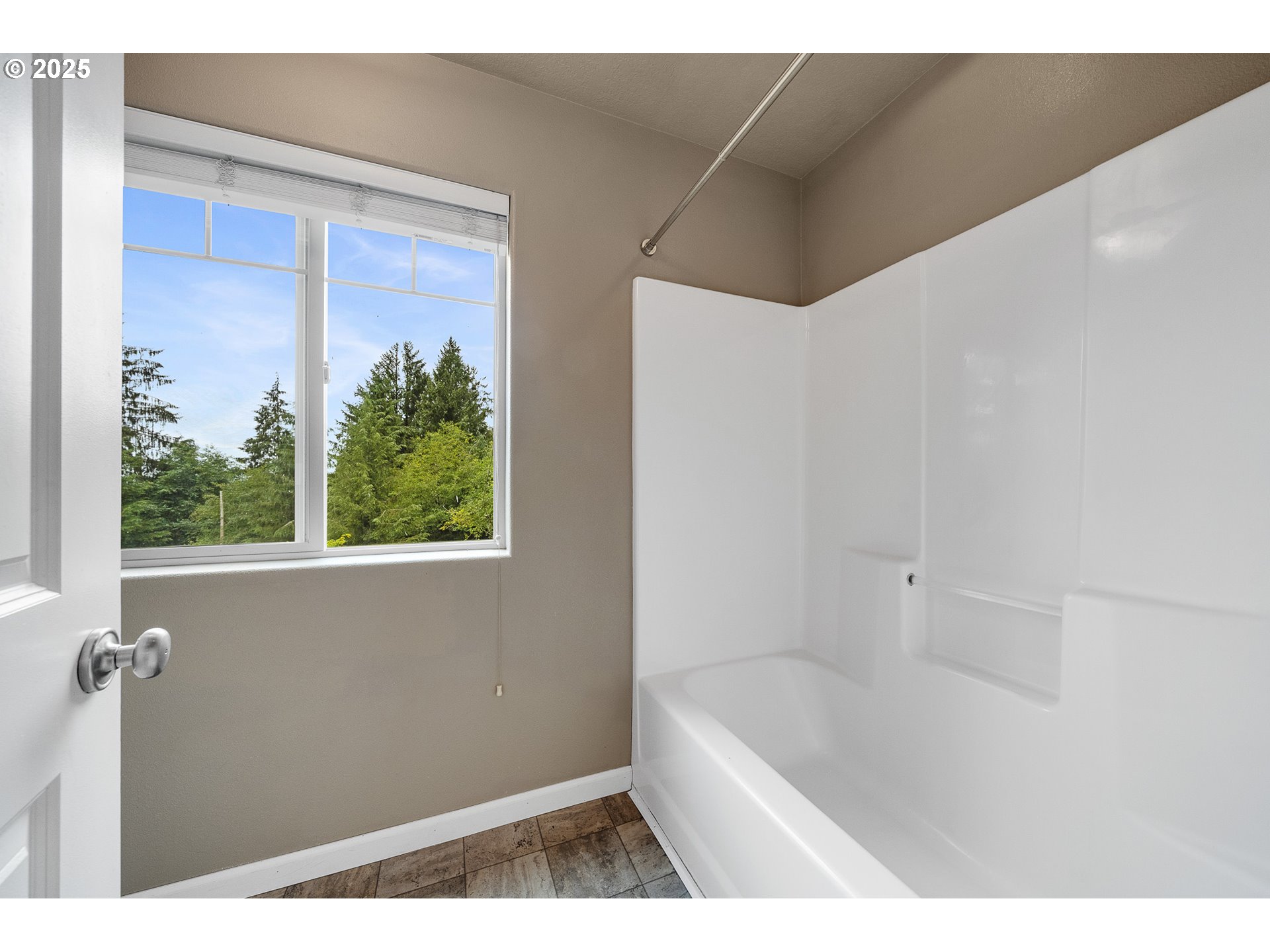 3355 Hubert Road Tillamook, OR 97141 - Photo 24 of 35 a bathroom with a tub a window and a shower