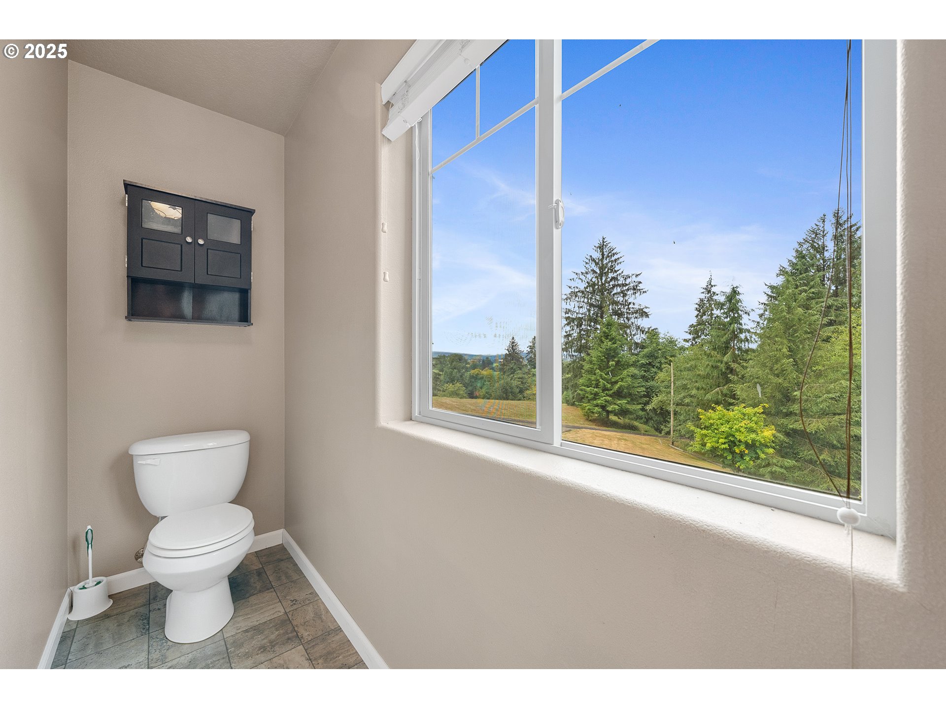 3355 Hubert Road Tillamook, OR 97141 - Photo 25 of 35 a bathroom with a toilet a sink and a window