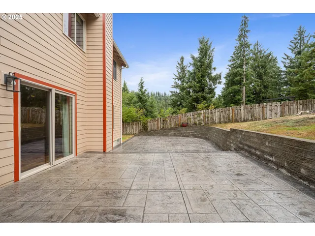 a view of a house with a yard and potted plants