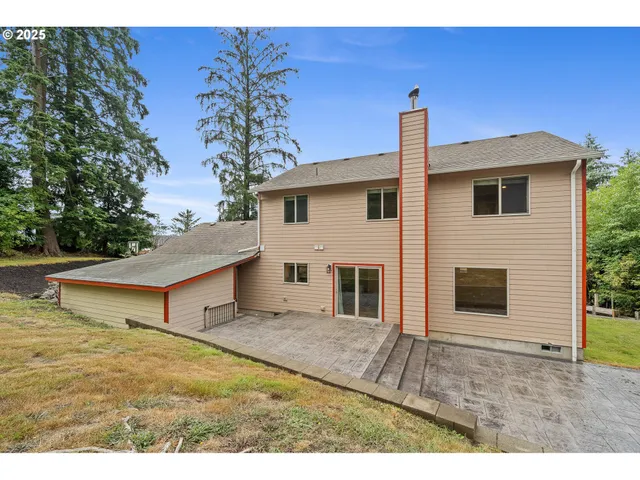 an aerial view of a house with a garden and swimming pool