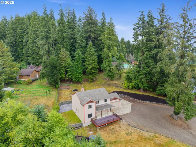 an aerial view of a house with a yard