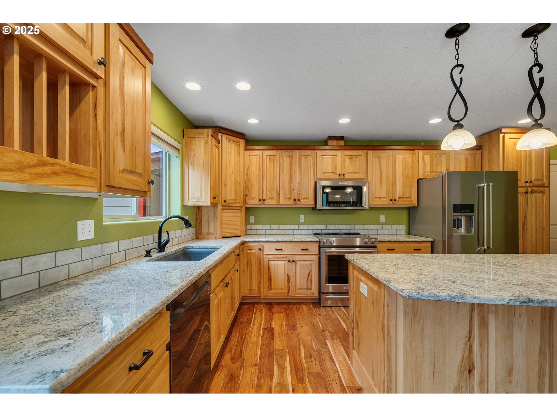 3355 Hubert Road Tillamook, OR 97141 - Photo 10 of 35 a kitchen with granite countertop a sink a counter top space stainless steel appliances and cabinets