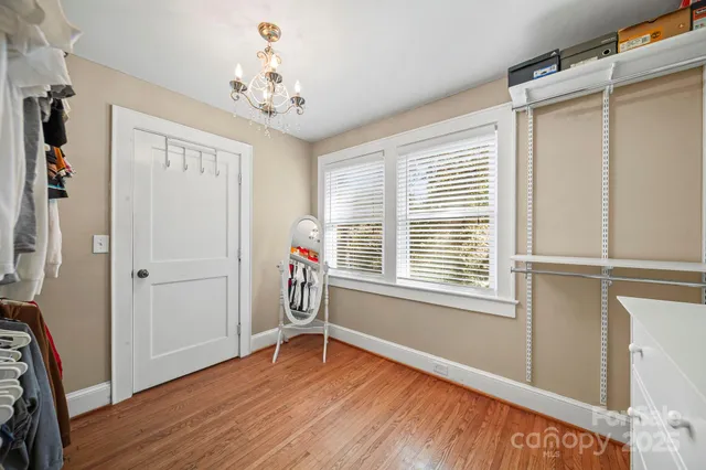 a very nice looking room with wooden floor and a window