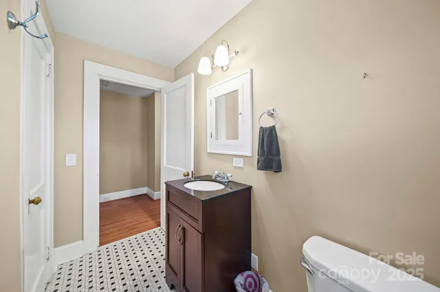 a bathroom with a sink a toilet and mirror
