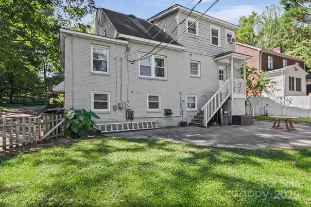 a view of a house with a yard and sitting area