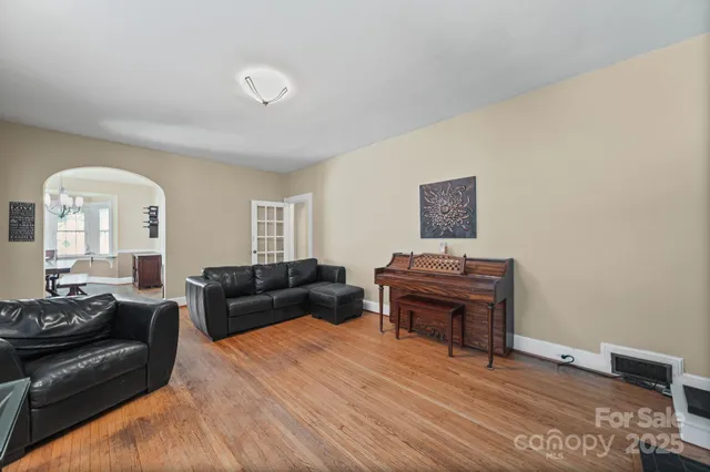 a living room with furniture and a piano