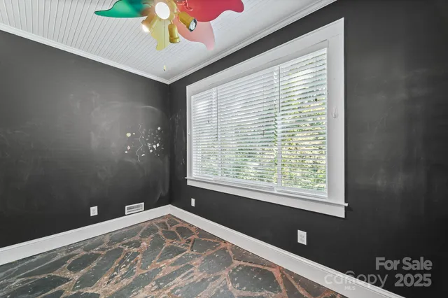 a view of a bedroom with a bed and a window