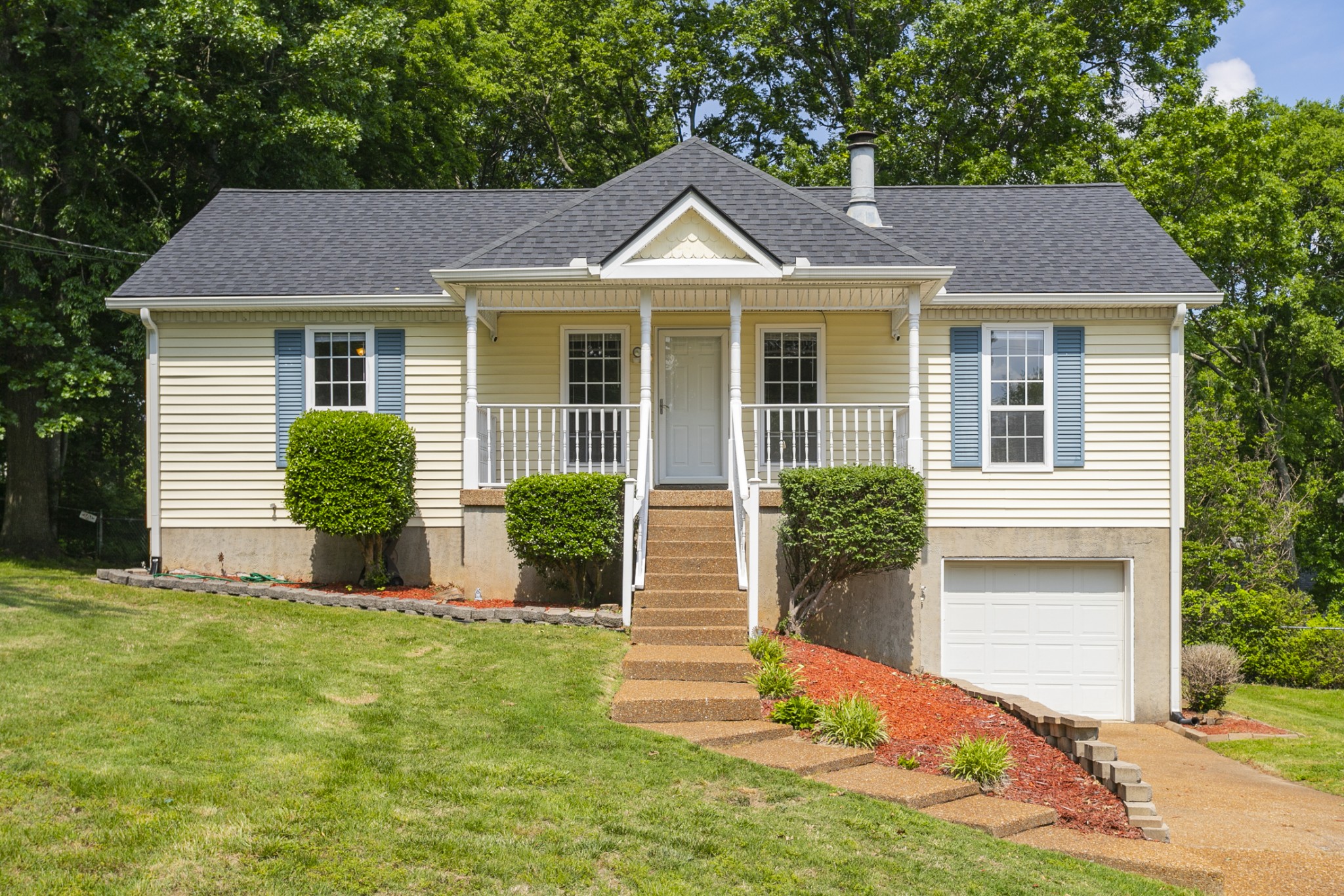 a front view of a house with a yard and garage