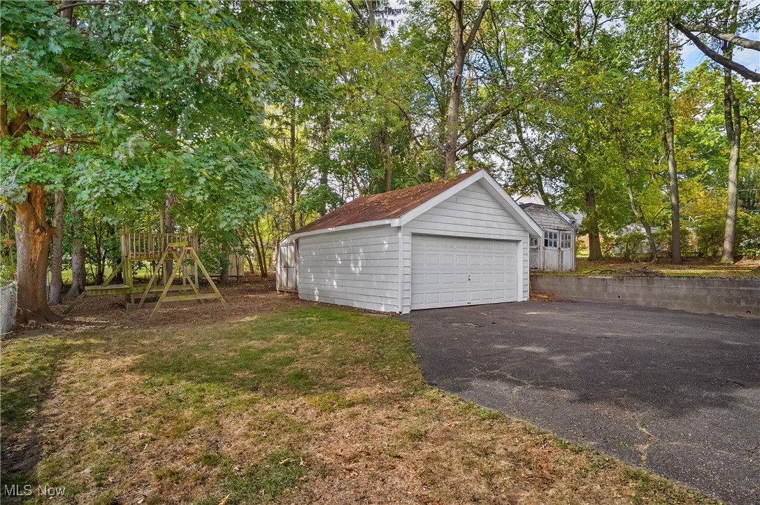 630 Ranney Street Akron, OH 44310 - Photo 29 of 33 View of the detached 2-car garage, shed behind it and parat of the backyard.