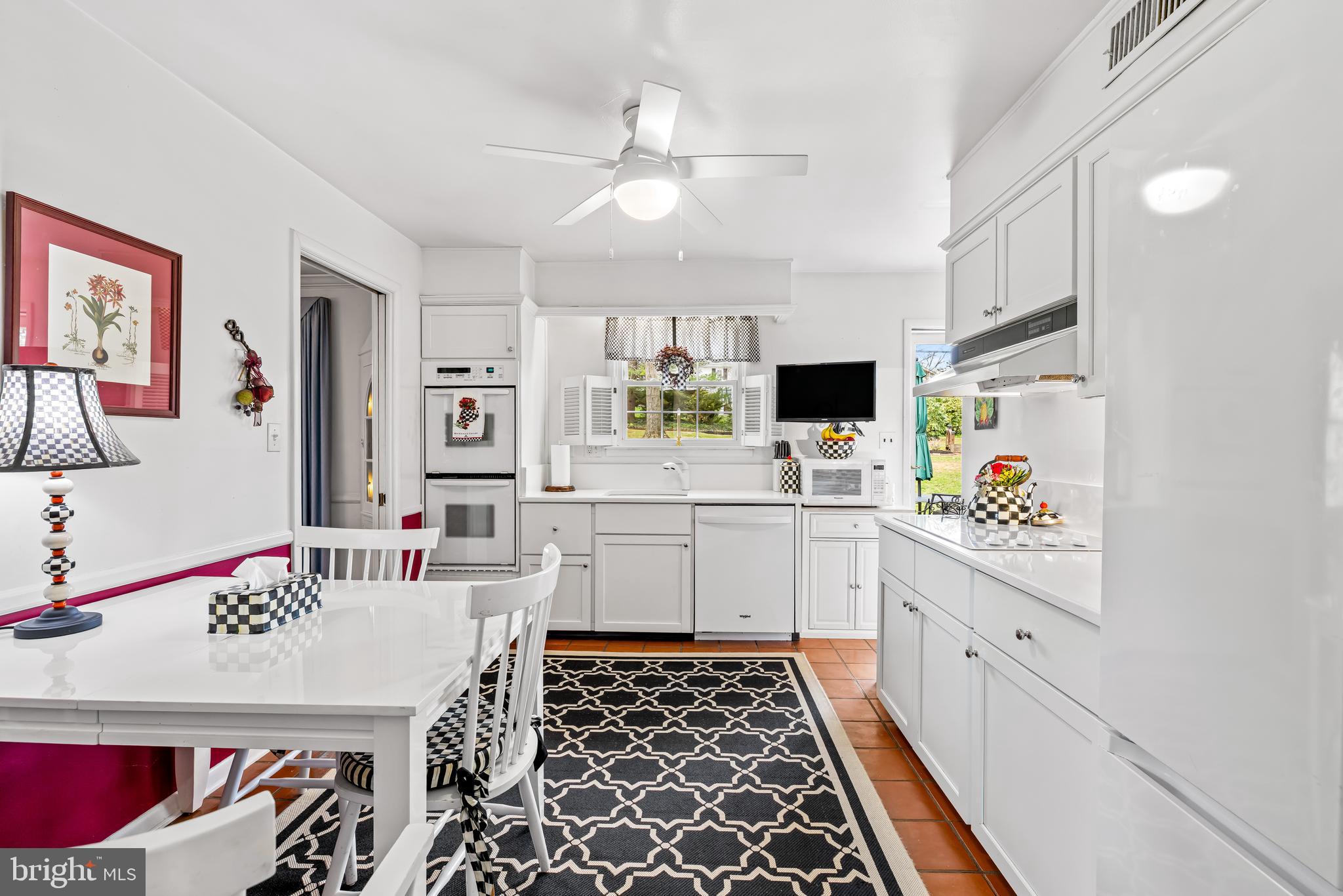 200 Purlington Road Lutherville-Timonium, MD 21093 - Photo 17 of 50 a large white kitchen with a sink a stove and white cabinets