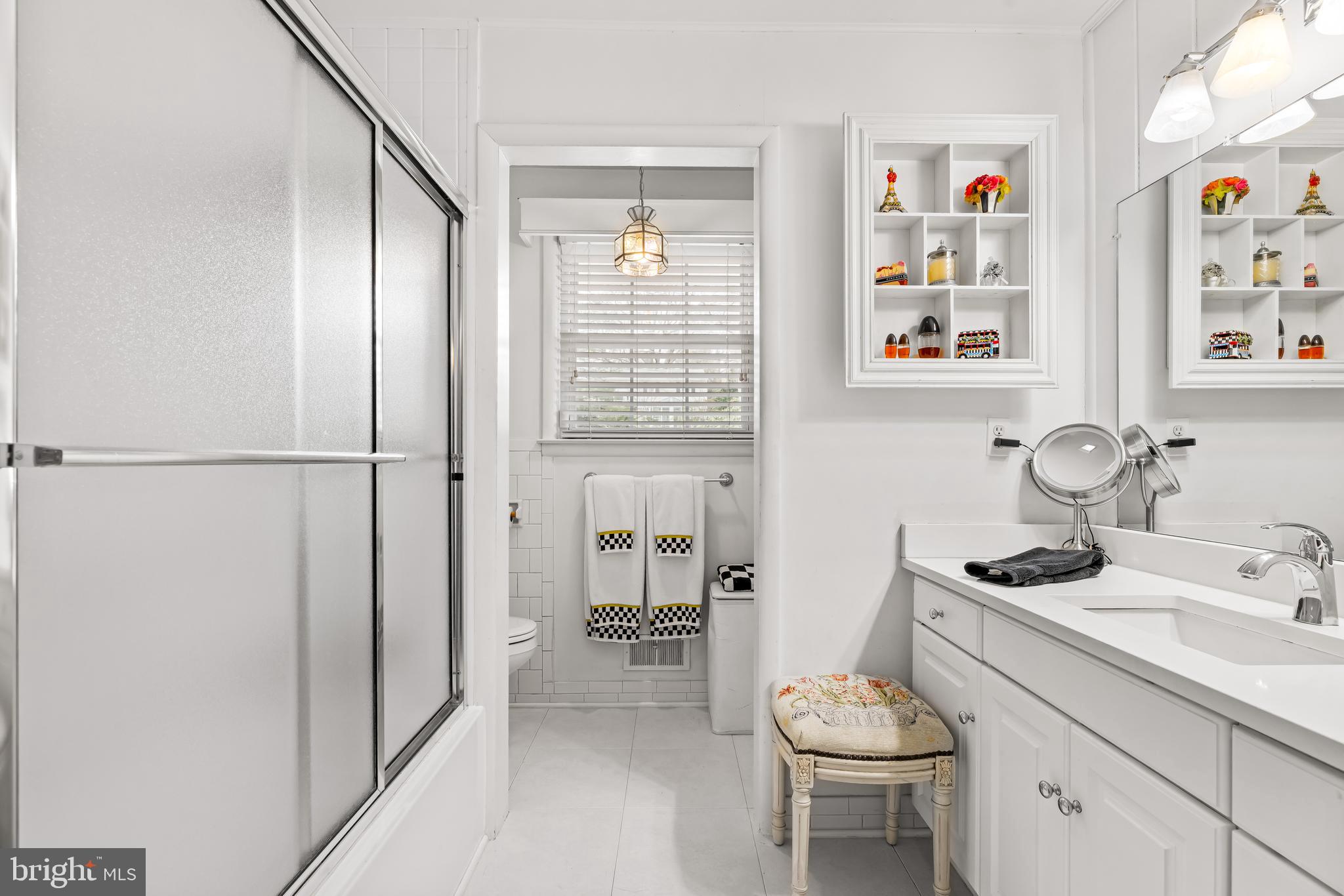 200 Purlington Road Lutherville-Timonium, MD 21093 - Photo 29 of 50 a bathroom with a granite countertop sink a toilet and a shower