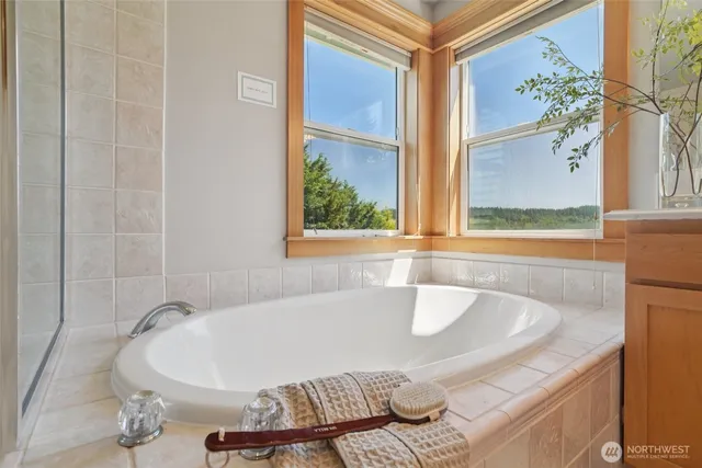 a bathroom with a bathtub and shower