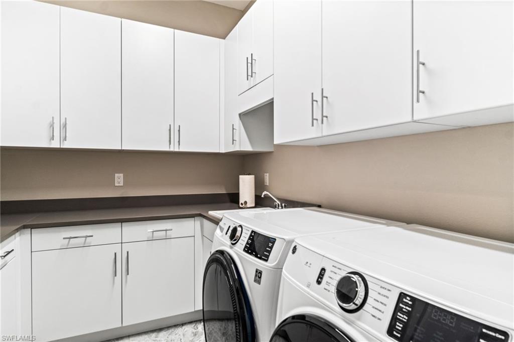 12033 Azalea Way Naples, FL 34120 - Photo 25 of 46 Abundant cabinetry, front loading washer and dryer, laundry sink