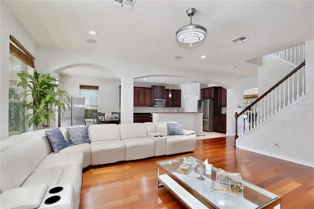 a bedroom with a bed a couch and a large window