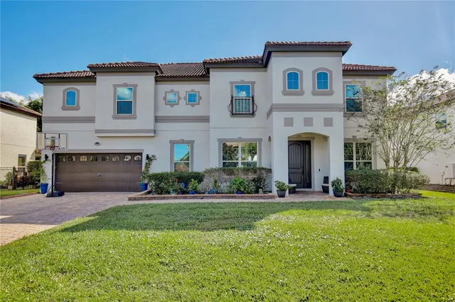 a front view of a house with a yard and garage