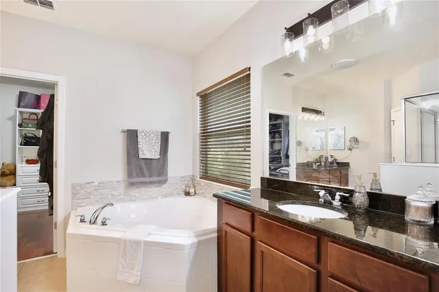 a living room with furniture and a ceiling fan