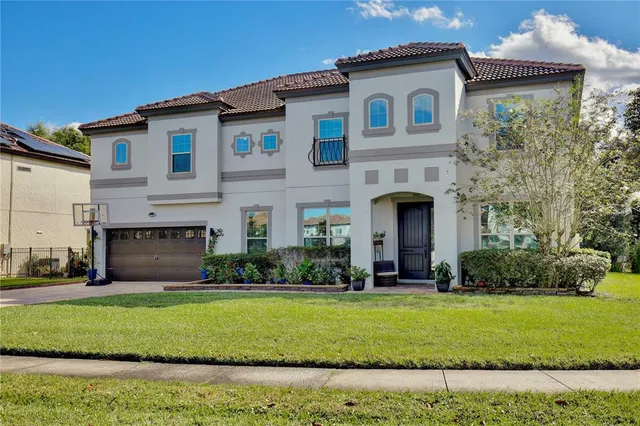 a front view of a house with a garden and yard