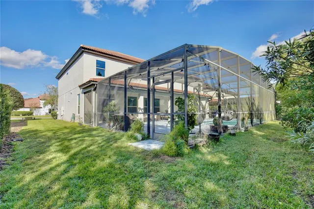 an aerial view of a city with lots of residential buildings and mountain view in back