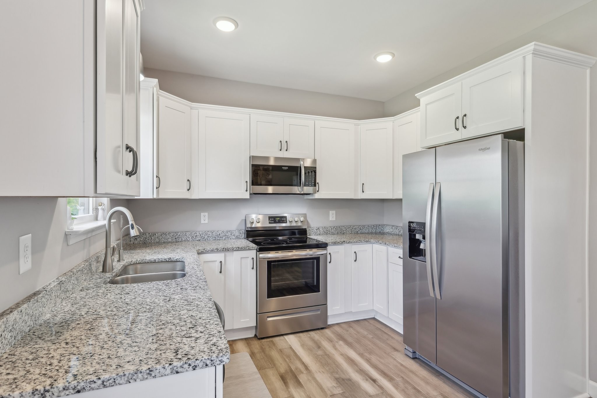 1219 Oak Grove Road Dickson, TN 37055 - Photo 4 of 52 a kitchen with white cabinets and stainless steel appliances