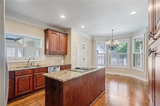a kitchen with granite countertop a sink and a refrigerator