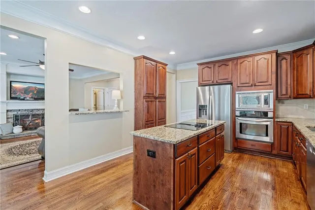 a kitchen that has a lot of cabinets in it and wooden floors