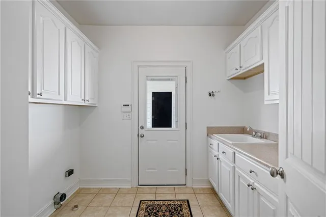 a kitchen with white cabinets and white appliances