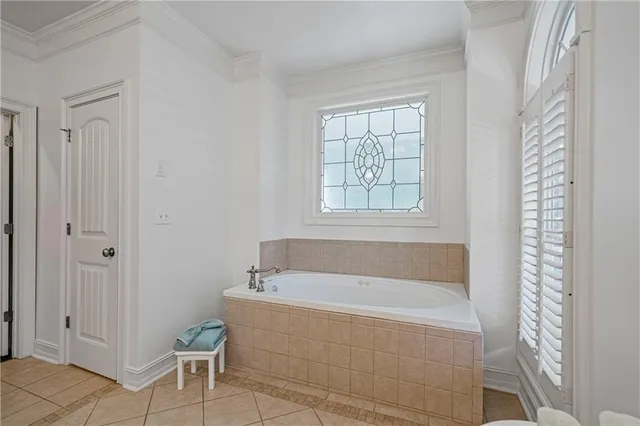 a bathroom with a tub shower and window