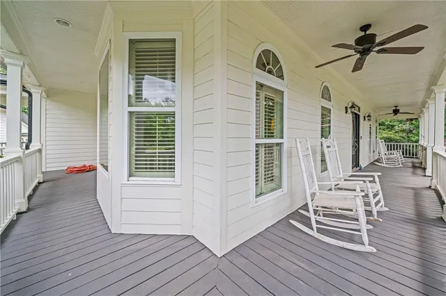 a view of a house with a big yard and large trees