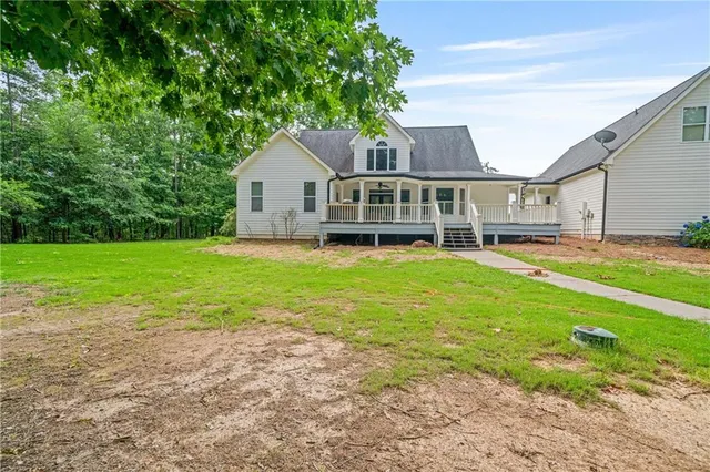 a view of an house with backyard and tree