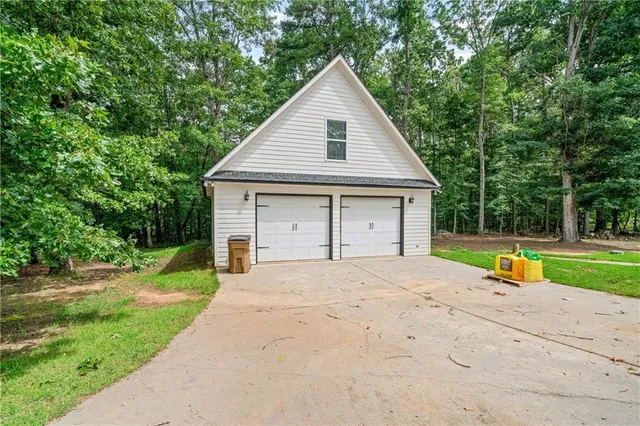 a view of an house with backyard and a tree