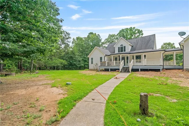 an aerial view of a house with a yard