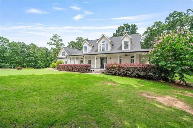 a backyard of a house with table and chairs