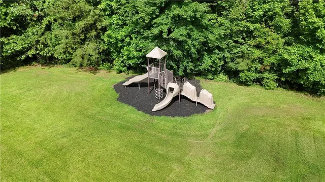 an aerial view of a house with a yard basket ball court and outdoor seating