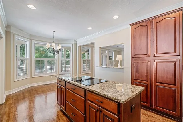 a bathroom with a granite countertop sink and a large mirror