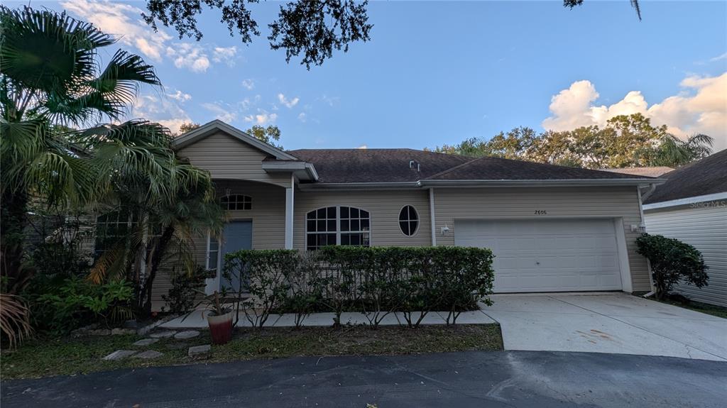 a front view of a house with a yard garage and outdoor seating