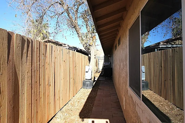 a backyard of a house with table and chairs