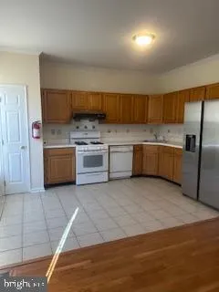 a kitchen with stainless steel appliances granite countertop a sink and a stove